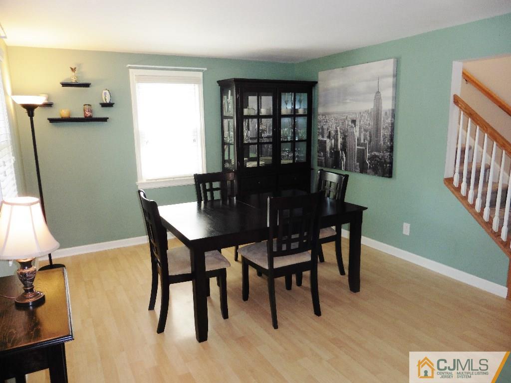 113 Highfield Road Colonia, NJ 07067 - Photo 6 of 25 a view of a dining room with furniture and a potted plant