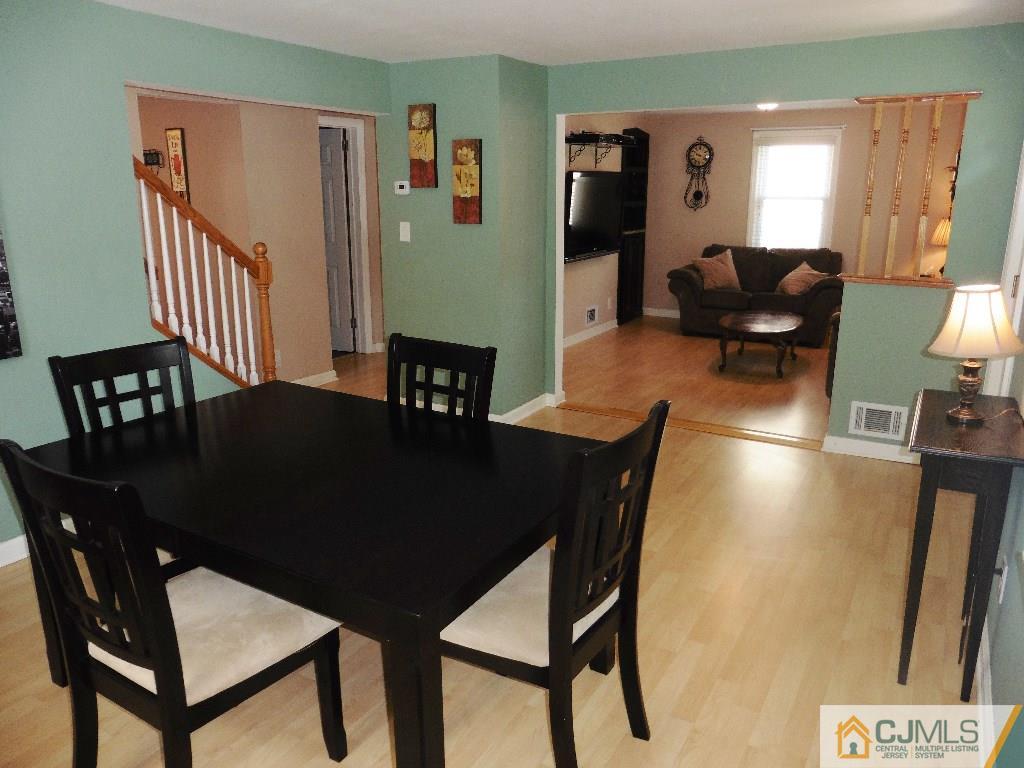 113 Highfield Road Colonia, NJ 07067 - Photo 9 of 25 a view of a dining room with furniture and wooden floor
