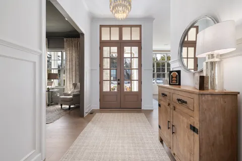a view of living room with furniture and a clock