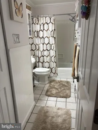 a white car parked in front of a house