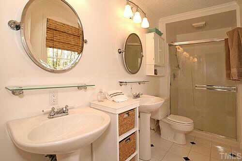 5409 Thayer Drive Raleigh, NC 27612 - Photo 7 of 12 Master bathroom has dual pedestal sinks and a stand up shower with bench. Other