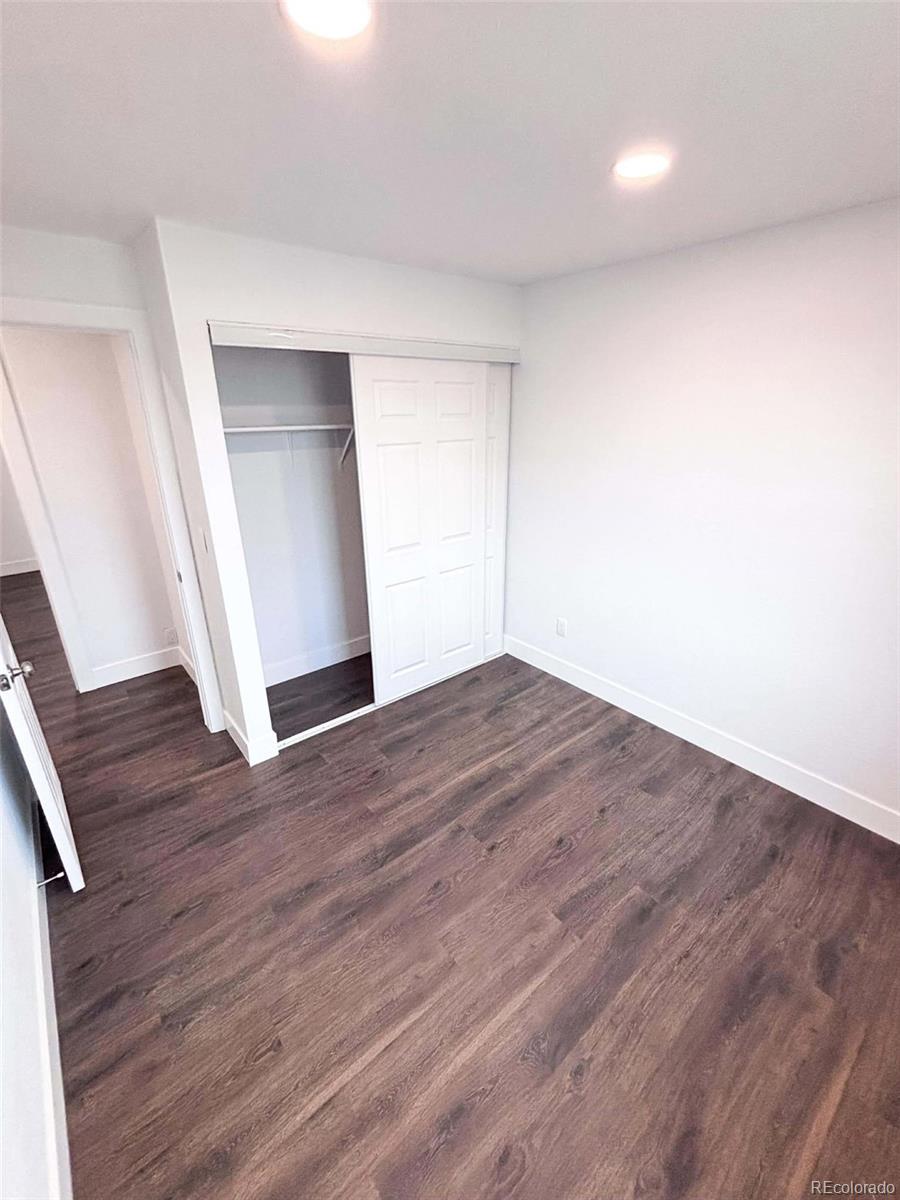 4295 Genoa Street Denver, CO 80249 - Photo 15 of 28 wooden floor in an empty room
