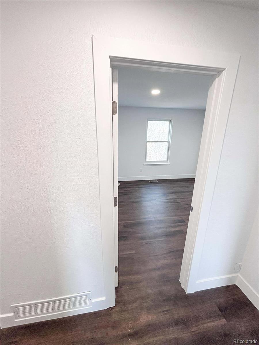 4295 Genoa Street Denver, CO 80249 - Photo 17 of 28 an empty room with wooden floor and closet