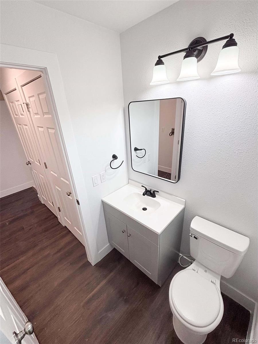 4295 Genoa Street Denver, CO 80249 - Photo 20 of 28 a white toilet sitting next to a bathroom sink