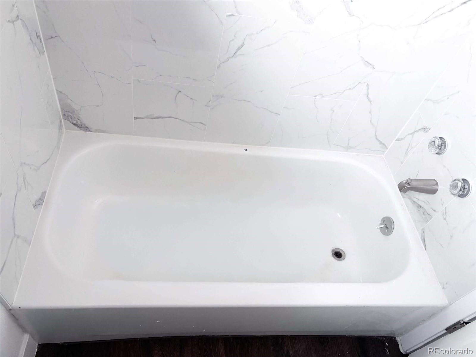 4295 Genoa Street Denver, CO 80249 - Photo 22 of 28 a bathroom with a bathtub