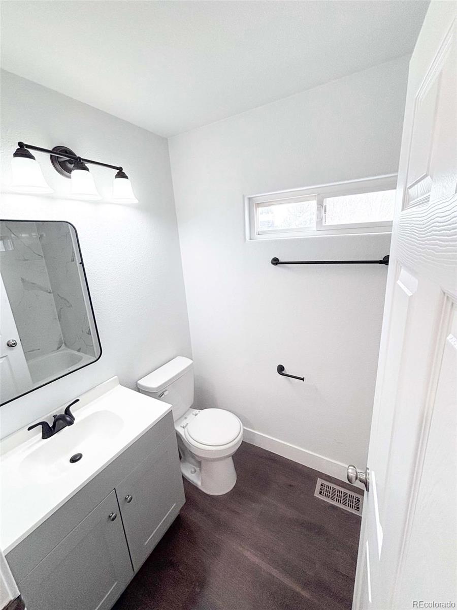 4295 Genoa Street Denver, CO 80249 - Photo 23 of 28 a bathroom with a sink toilet and shower