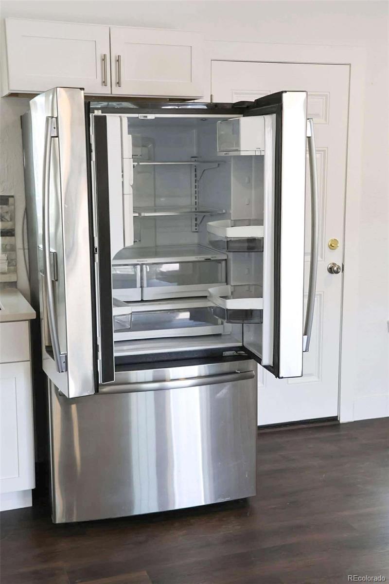 4295 Genoa Street Denver, CO 80249 - Photo 6 of 28 a metallic refrigerator freezer sitting inside of a kitchen