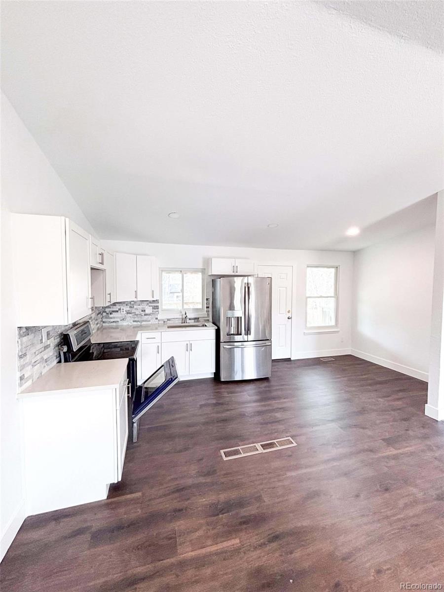 4295 Genoa Street Denver, CO 80249 - Photo 7 of 28 a view of a kitchen with a sink cabinets and a window