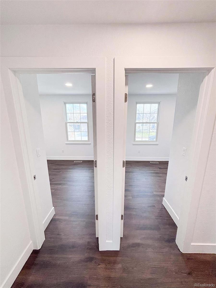4295 Genoa Street Denver, CO 80249 - Photo 10 of 28 an empty room with wooden floor and windows