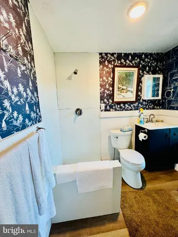 a bathroom with a sink toilet bathtub and mirror