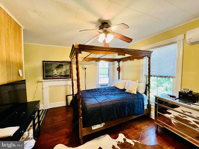 a bed sitting in a bedroom next to a window