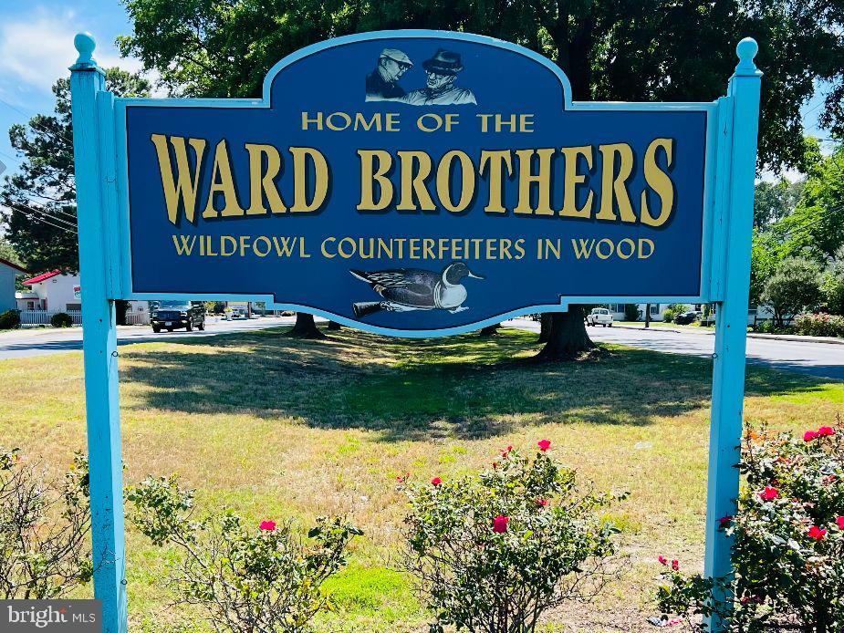 232 North Somerset Avenue Crisfield, MD 21817 - Photo 32 of 42 a sign that is sitting in front of flowers
