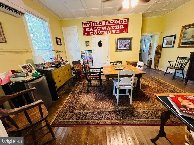 a living room with chairs and rug