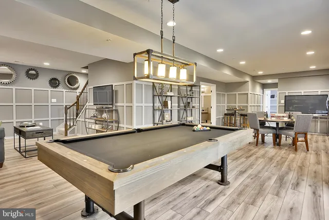 a dining room with a wooden table and chairs