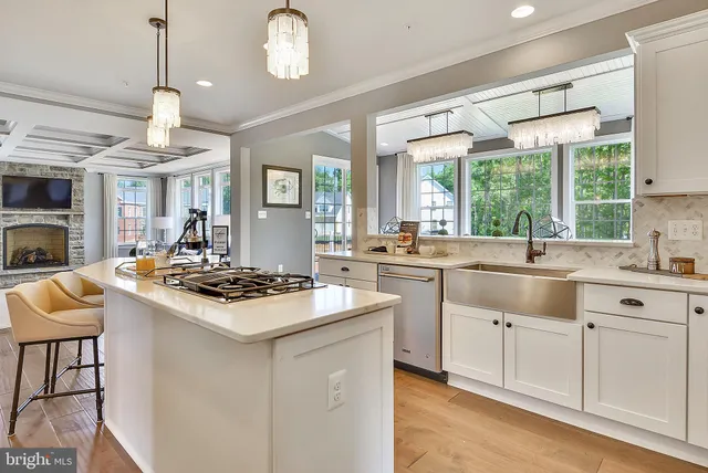 a kitchen with a stove a sink a dining table and chairs