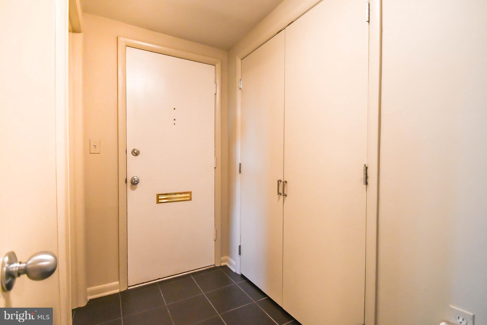 103 A Cross Keys Road, Unit R103A Baltimore, MD 21210 - Photo 5 of 19 Entrance Foyer with mail slot and ceramic tile