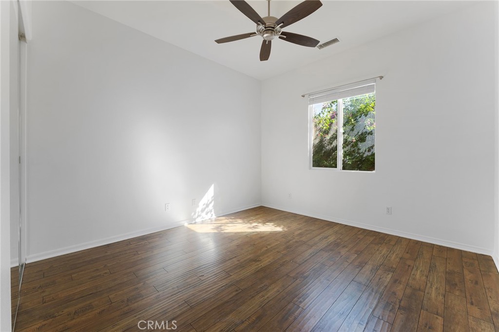 7 Lake Como Court Rancho Mirage, CA 92270 - Photo 17 of 42 a view of an empty room with wooden floor and a window