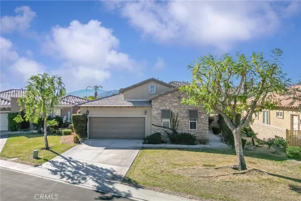 a view of a house with a yard and tree s