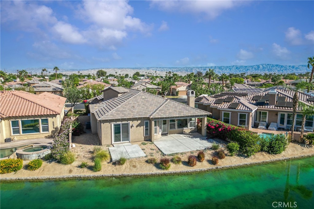7 Lake Como Court Rancho Mirage, CA 92270 - Photo 34 of 42 a front view of a house with a yard table and chairs