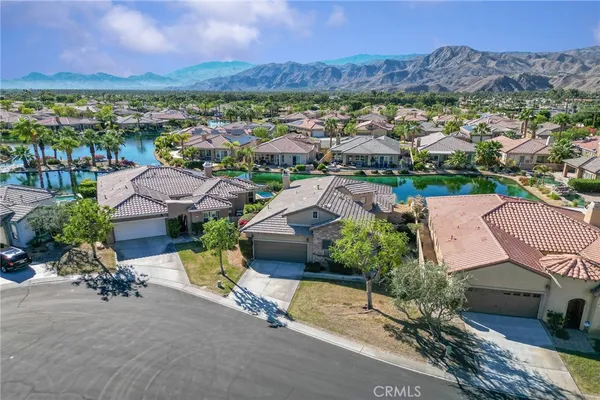 an aerial view of residential houses with outdoor space and mountain view