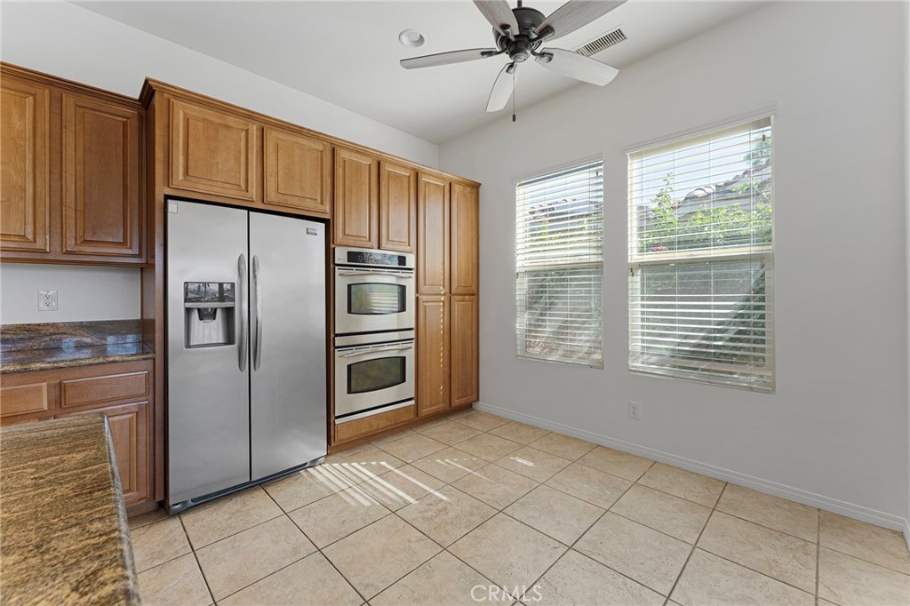 7 Lake Como Court Rancho Mirage, CA 92270 - Photo 6 of 42 a kitchen with granite countertop a refrigerator and a sink