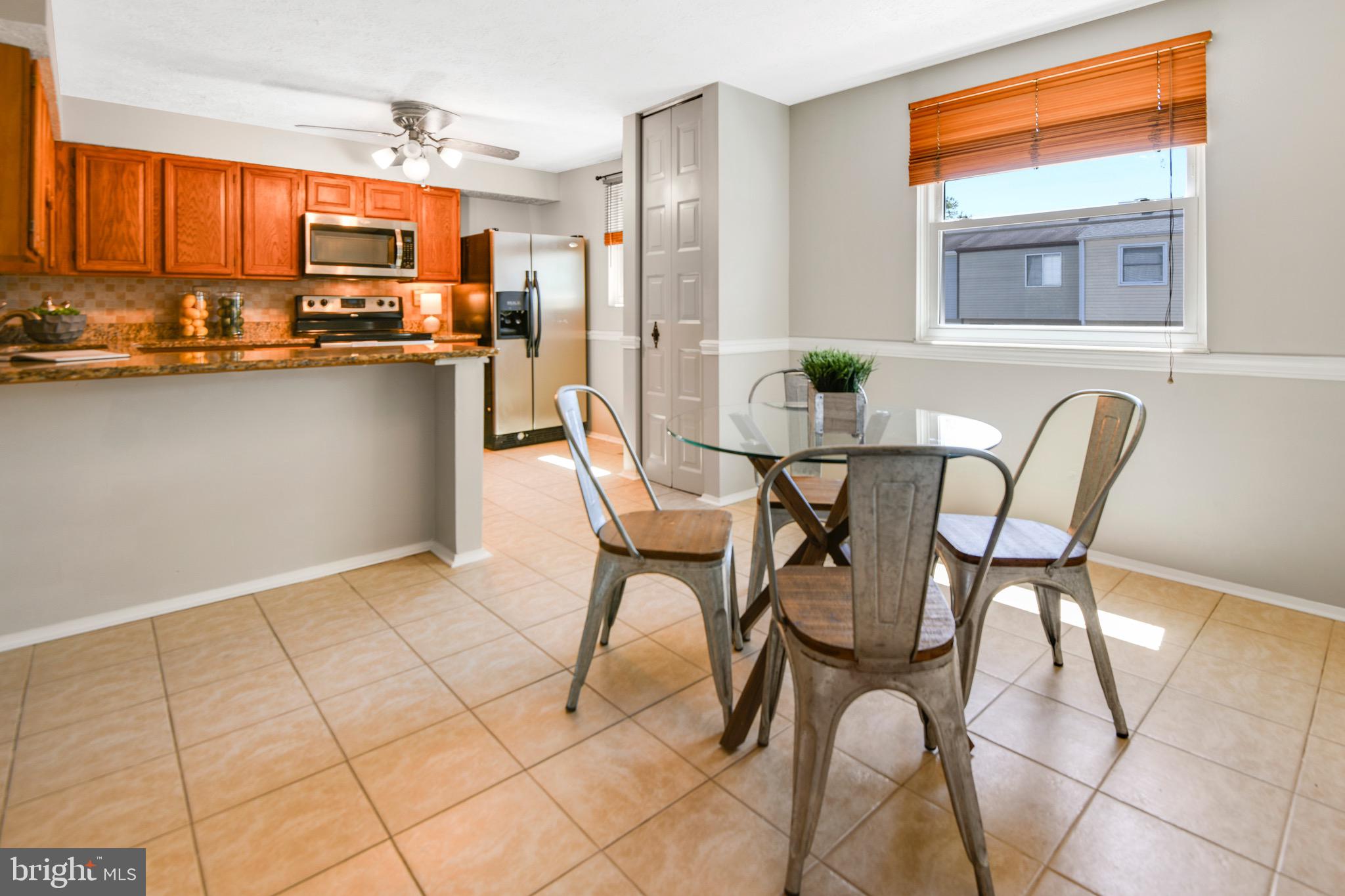 7025 Hames Court Frederick, MD 21703 - Photo 5 of 22 a dining room with furniture and a kitchen view