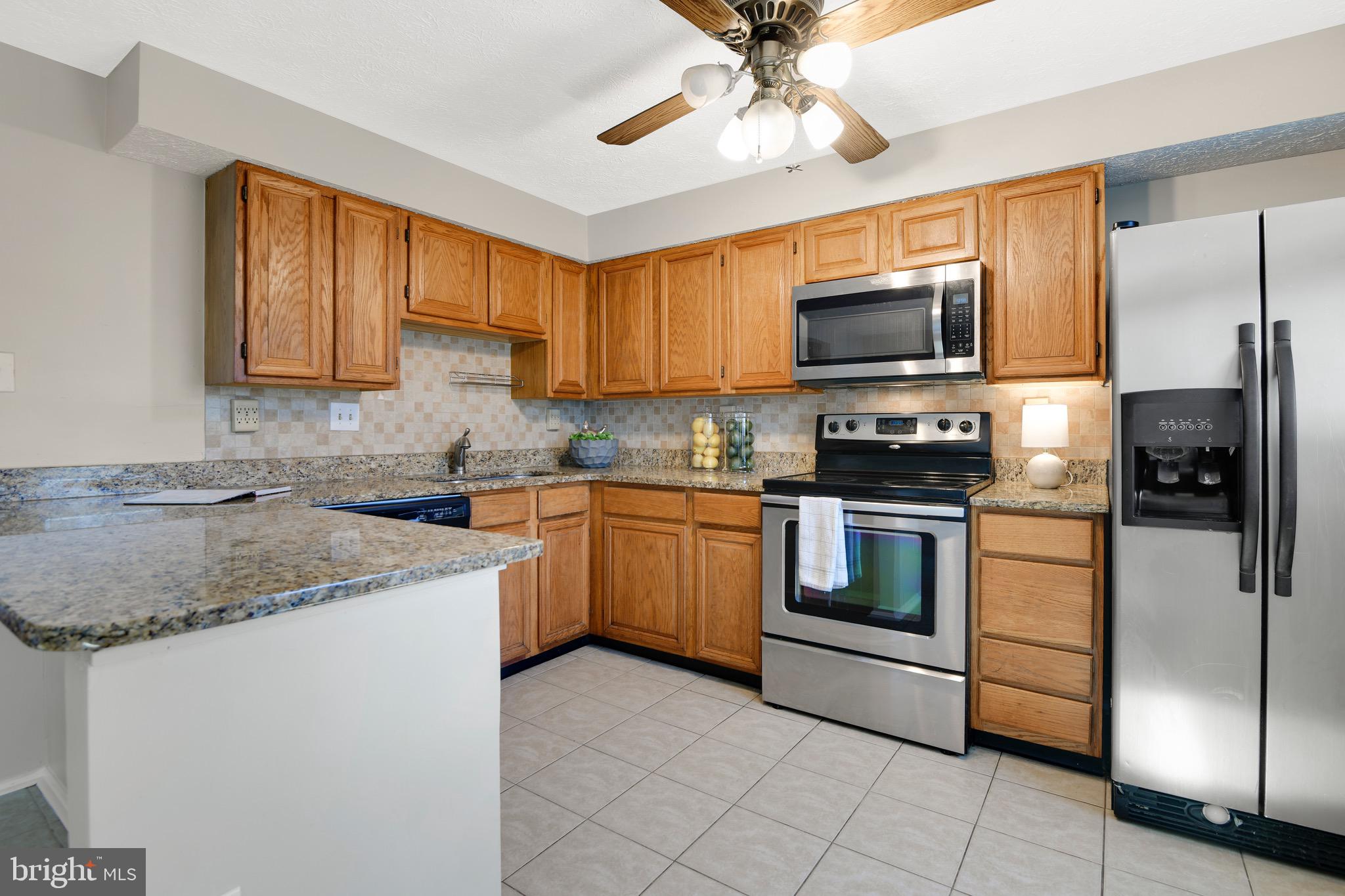 7025 Hames Court Frederick, MD 21703 - Photo 6 of 22 a kitchen with a sink stove and microwave