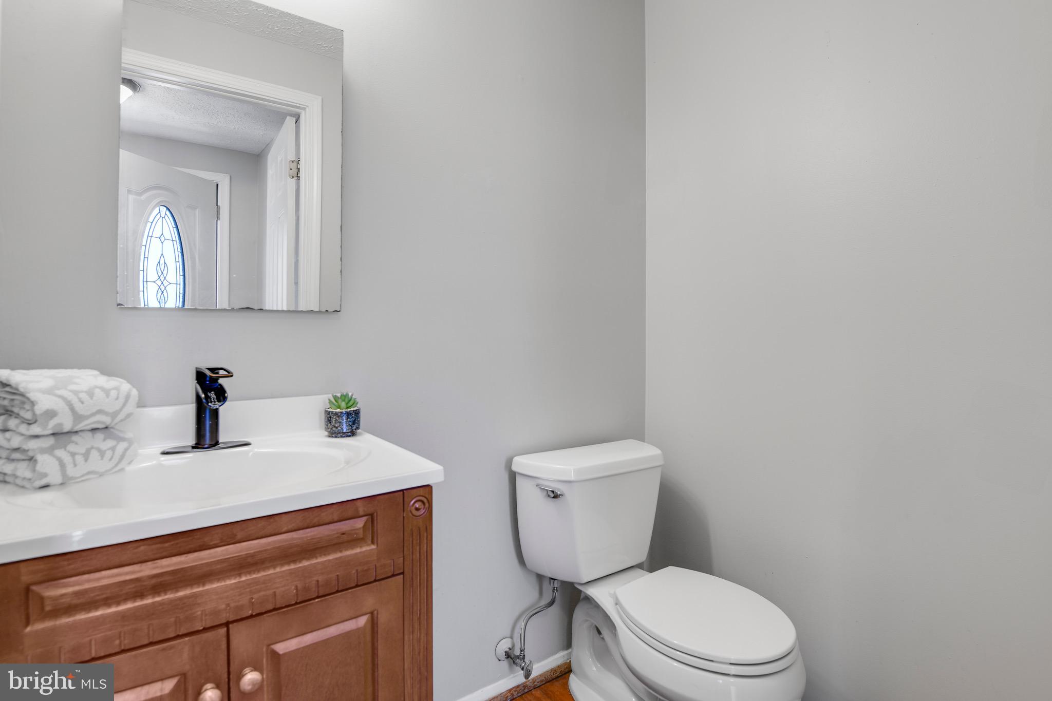 7025 Hames Court Frederick, MD 21703 - Photo 9 of 22 a white toilet sitting next to a bathroom sink