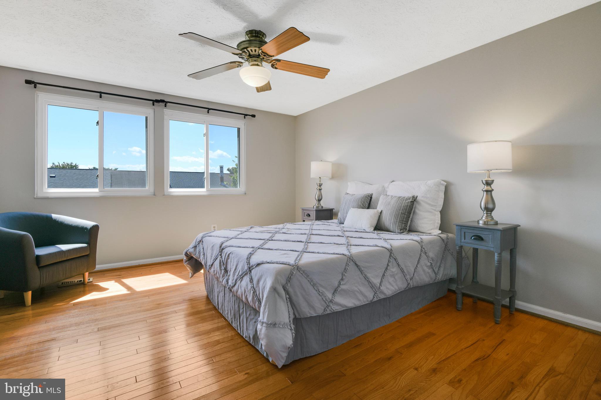 7025 Hames Court Frederick, MD 21703 - Photo 10 of 22 a bedroom with a bed and a chandelier