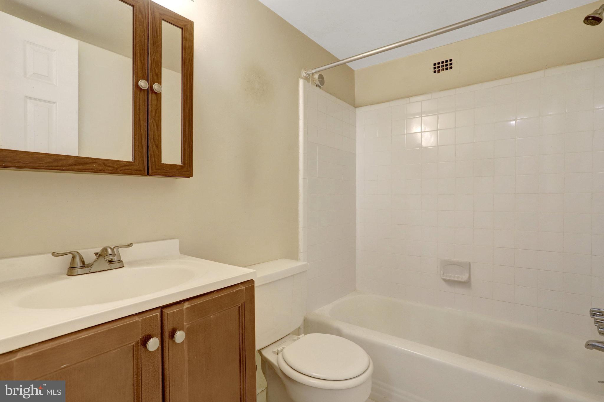 5565 Columbia Pike, Unit 412 Arlington, VA 22204 - Photo 20 of 25 a bathroom with a sink a toilet and shower