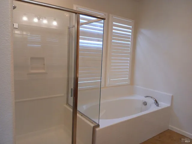 a bathroom with a bathtub and a shower