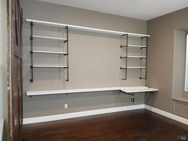 a view of a room with shelves on the wall
