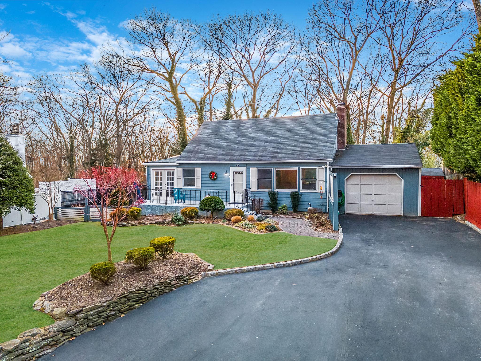 22 Laurelton Road Sound Beach, NY 11789 - Photo 1 of 1 Cape-style house with a front yard and a garage