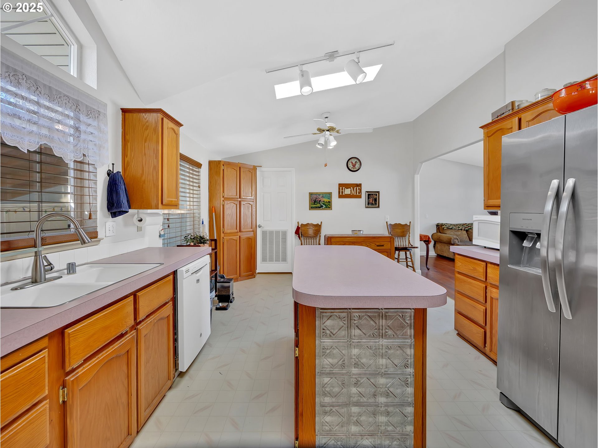 1819 Southeast Orient Drive, Unit 8 Gresham, OR 97080 - Photo 15 of 30 a kitchen with stainless steel appliances kitchen island granite countertop a sink dishwasher and a refrigerator with wooden floor