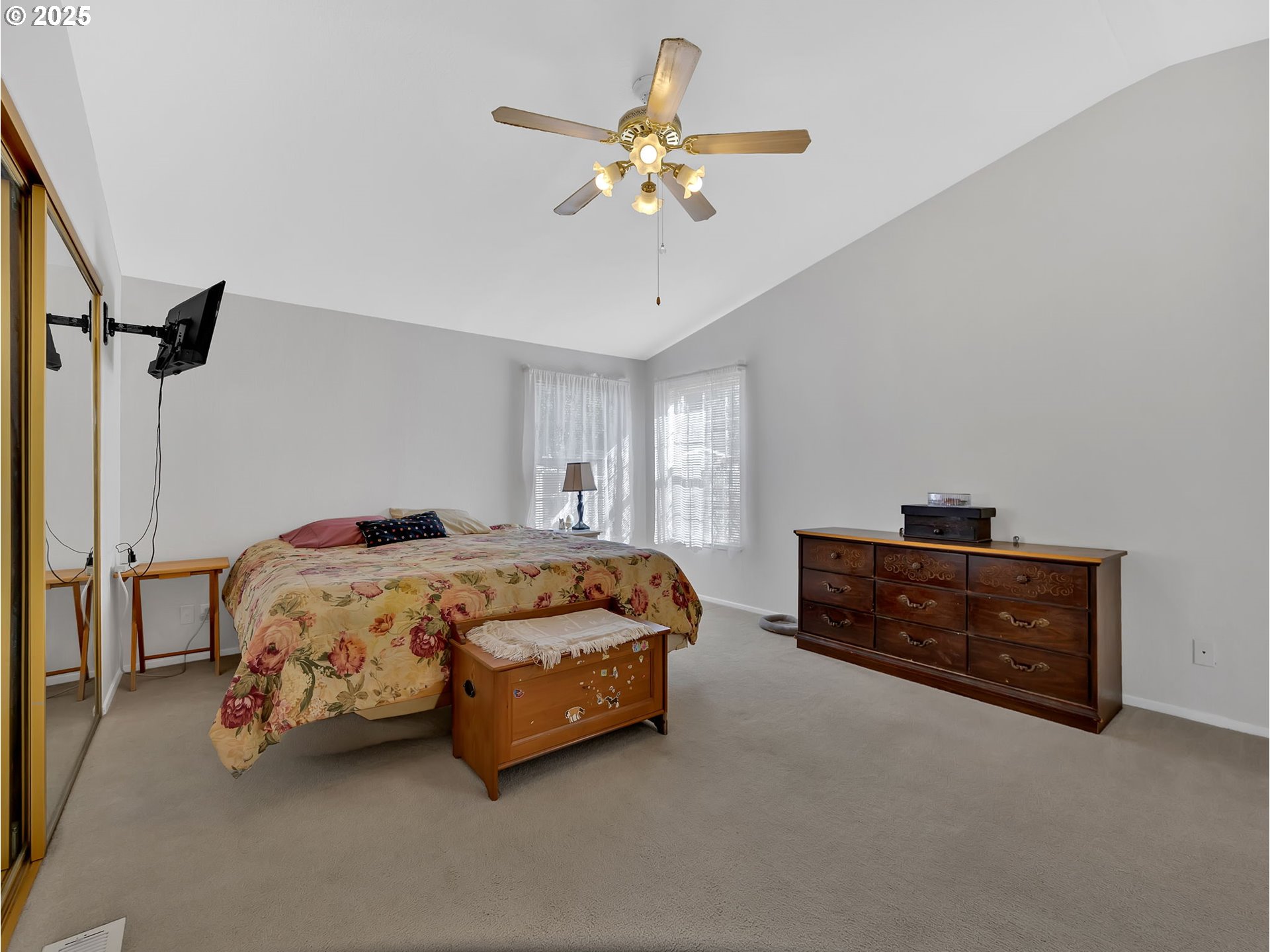1819 Southeast Orient Drive, Unit 8 Gresham, OR 97080 - Photo 18 of 30 a spacious bedroom with a bed and a chandelier