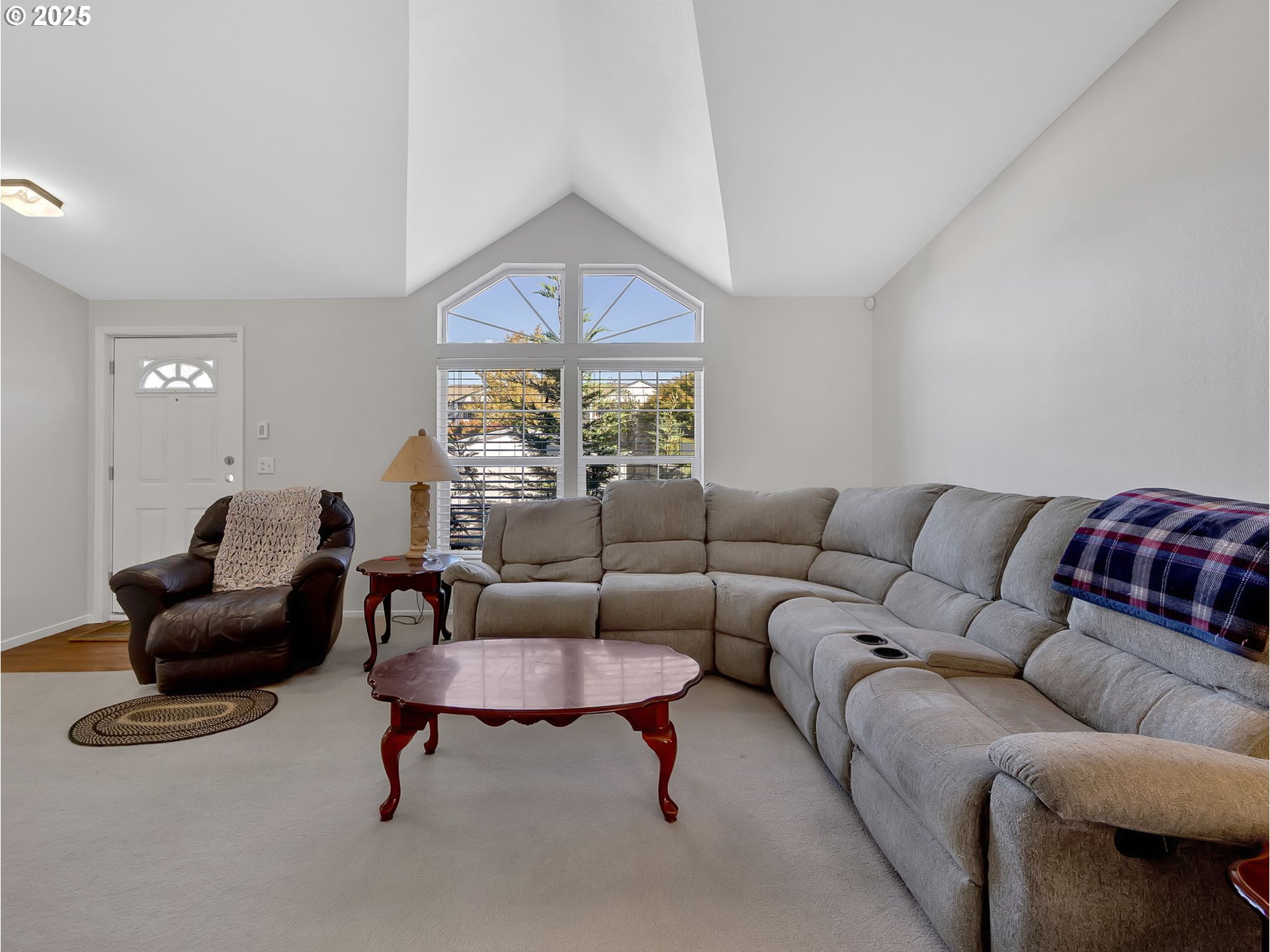 1819 Southeast Orient Drive, Unit 8 Gresham, OR 97080 - Photo 5 of 30 a living room with furniture a rug and a chandelier