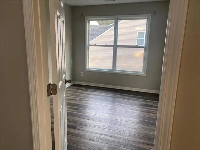 a view of a room with wooden floor and window