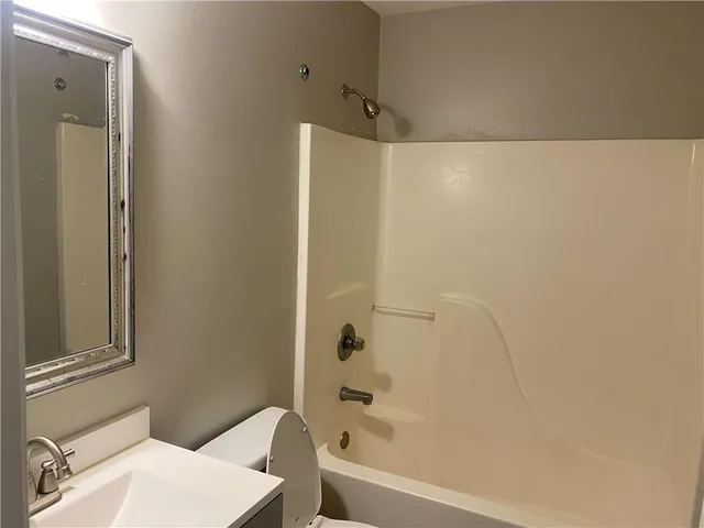 a bathroom with a bathtub and a sink