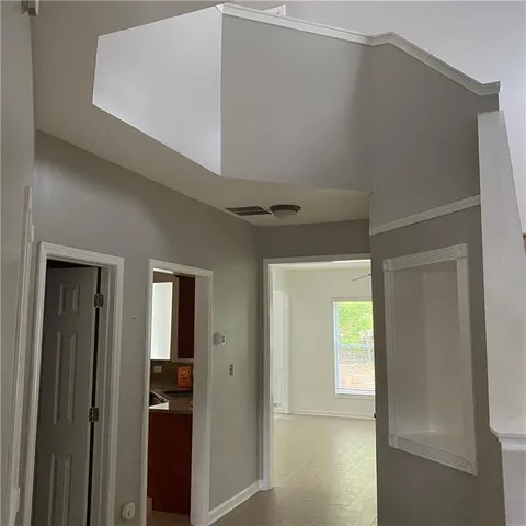 a view of a hallway with closet and front door