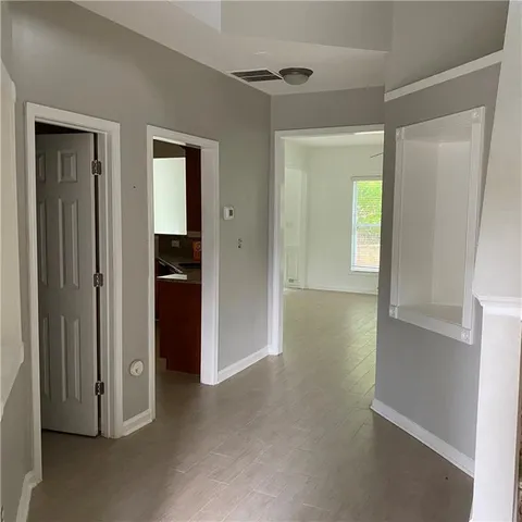 an empty room with windows and closet