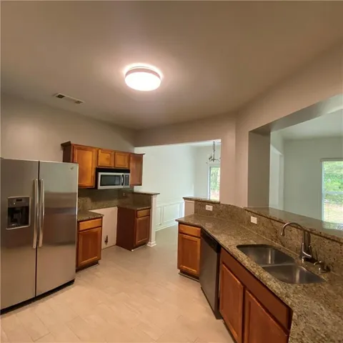a kitchen with a sink stove and refrigerator