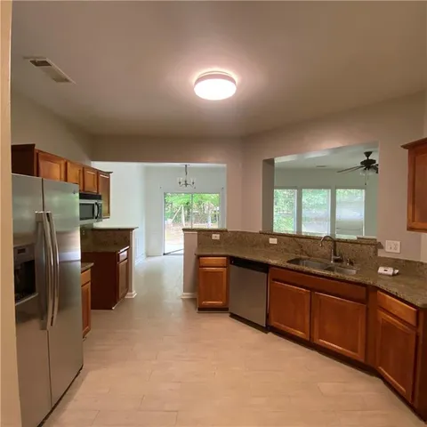 a large kitchen with a large counter top appliances and cabinets