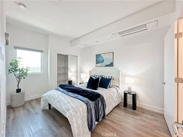a bedroom with a bed and a potted plant
