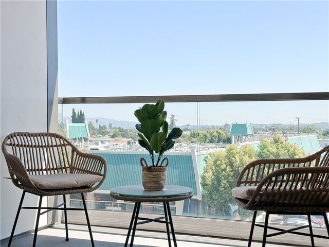 a view of a balcony with furniture
