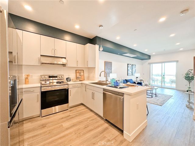 a kitchen with stainless steel appliances and white cabinets