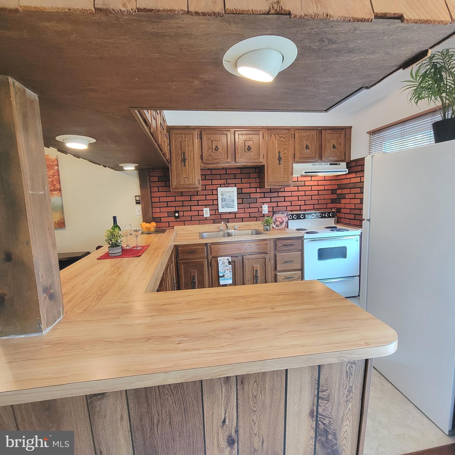 18 Ridge Road Greenbelt, MD 20770 - Photo 7 of 31 a large kitchen with stainless steel appliances granite countertop a sink and cabinets