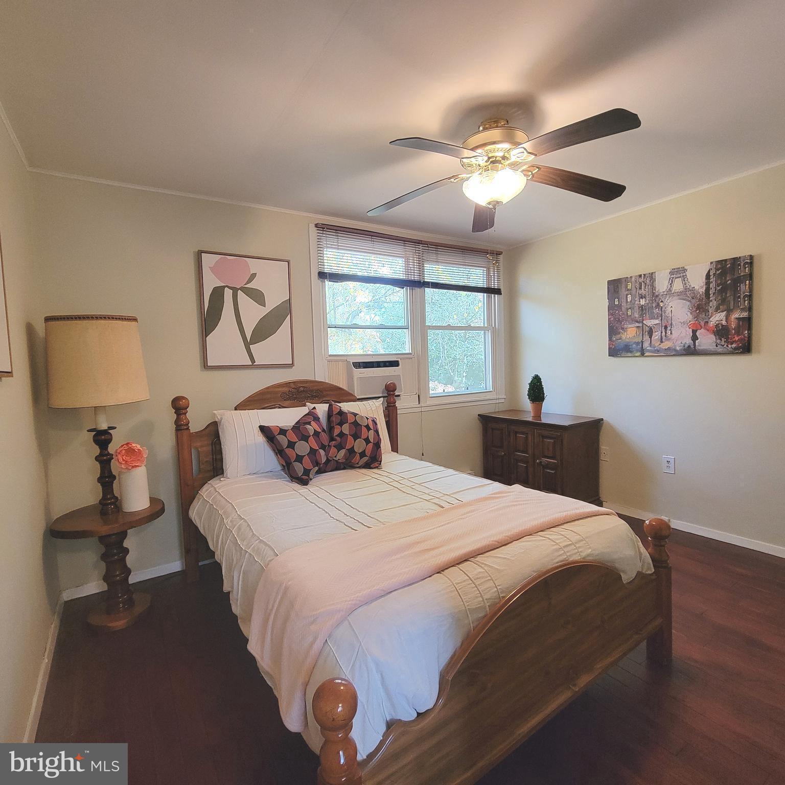 18 Ridge Road Greenbelt, MD 20770 - Photo 10 of 31 a bedroom with a large bed and a chandelier