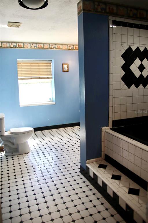 786 Southwest Bozeman Court Lake City, FL 32024 - Photo 23 of 32 a bathroom with a sink a toilet and a shower