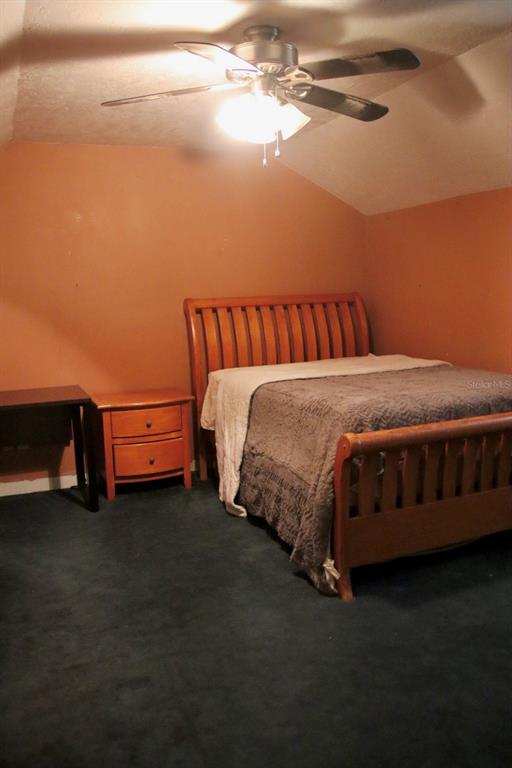 786 Southwest Bozeman Court Lake City, FL 32024 - Photo 27 of 32 a bed sitting in a bedroom next to a lamp