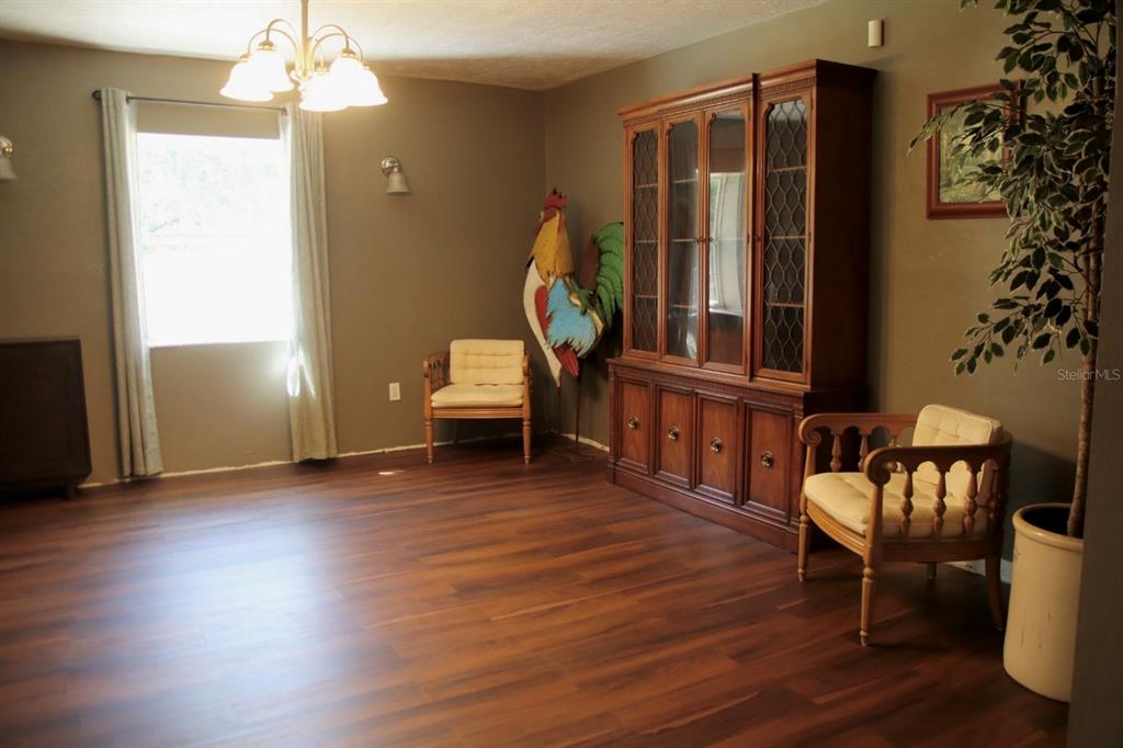 786 Southwest Bozeman Court Lake City, FL 32024 - Photo 6 of 32 a living room with furniture a dining table chairs and wooden floor